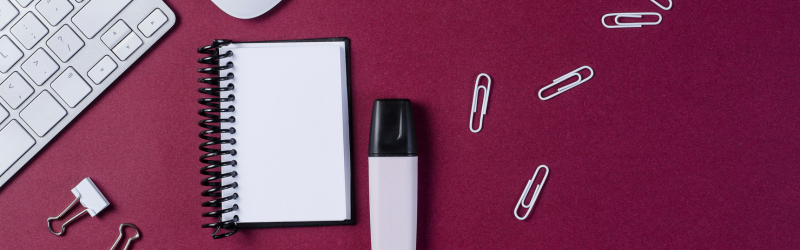 keyboard, paperclips, binder clips, notepad, and marker